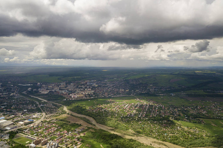 Aerial view of town or village with rows of buildings and curvy 