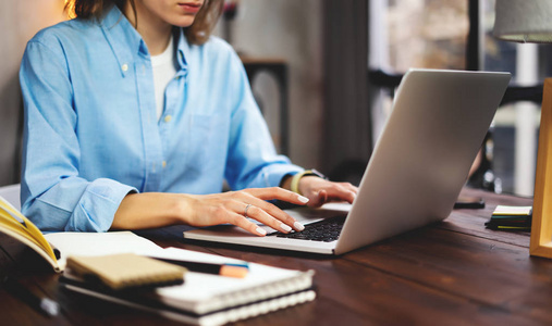 Young woman working with a laptop. Female freelancer connecting 