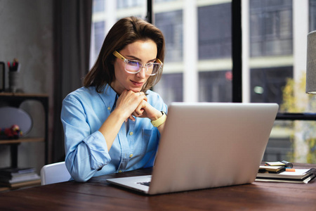 Young woman working with a laptop. Female freelancer connecting 