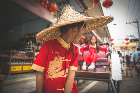 Young asian boy and girl in Chinese costume playing together in 