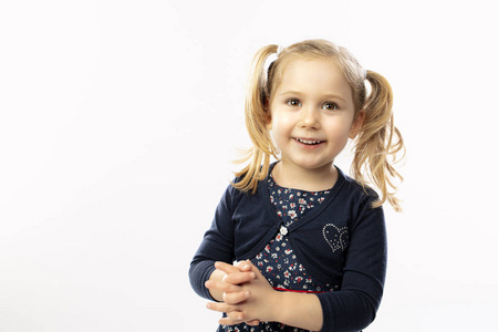 Studio portrait of a 3 year old blond girl 