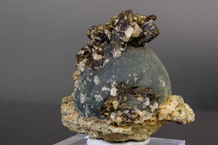 macro mineral stone Prehnite on Epidote on a gray background 