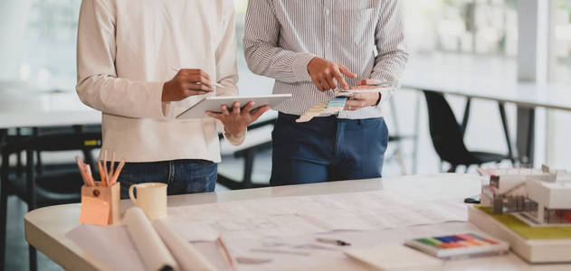 Cropped shot of architect and engineer working together on toget