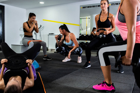 Fitness coach looking over her girls 