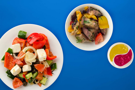  Greek salad on a colored background. Greek salad on a white pla