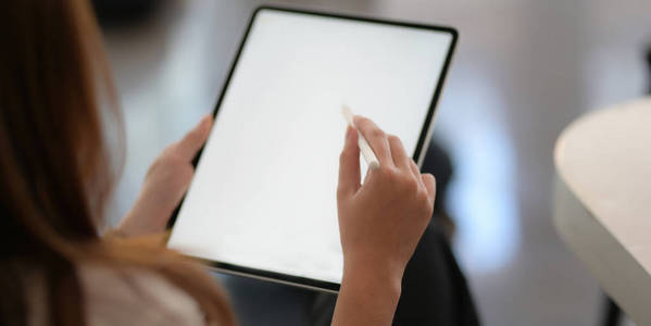 Businesswoman working on her project with blank screen digital t