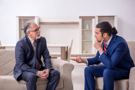 两个商人在办公室讨论生意照片