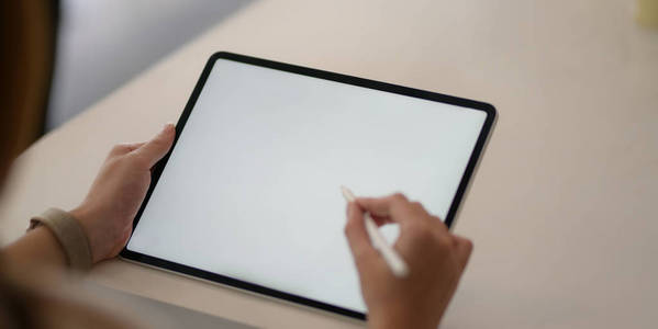 Cropped shot of young businesswoman working with blank screen la