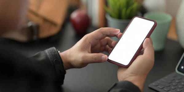 Cropped shot of young businessman using blank screen smartphone 