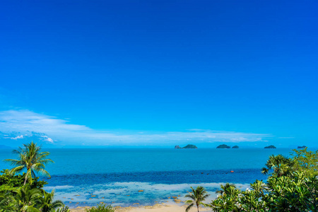 Beautiful tropical sea ocean with coconut palm tree on blue sky 