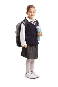 Schoolgirl in a uniform holding books 