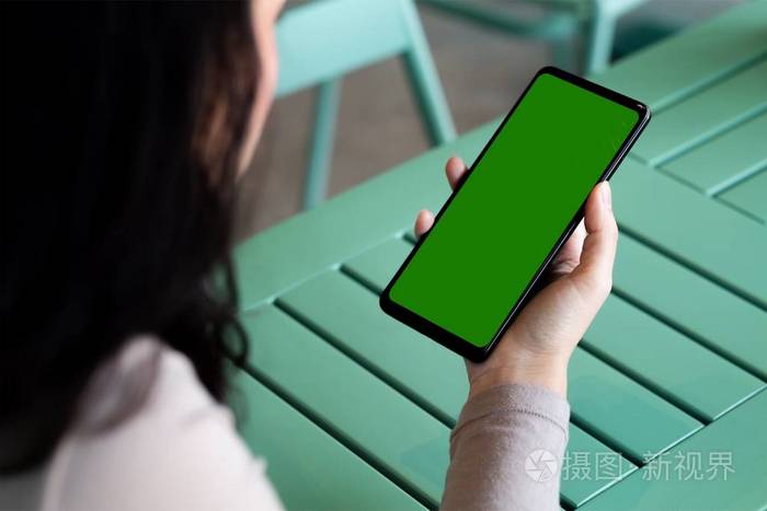 A woman and green screen on black smartphone 