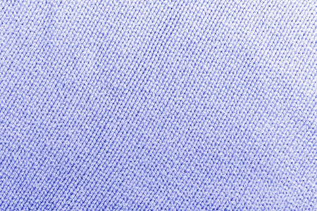 经典的蓝色针织物羊毛质地为背景。设计用蓝色针织物图案的特写镜头。蓝色保暖毛衣织物背景。彩绘织物织物的纹理波浪。蓝色调色