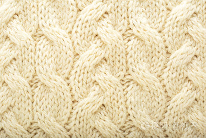 米色针织物羊毛质地为背景白色针织物图案的特写设计米色保暖毛衣织物