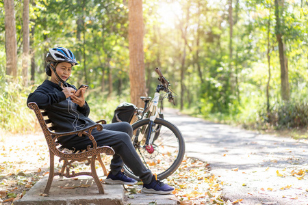 Senior asian woman bicycle with sitting in the park, With using 