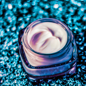 Luxury face cream for healthy skin on shiny glitter background, 