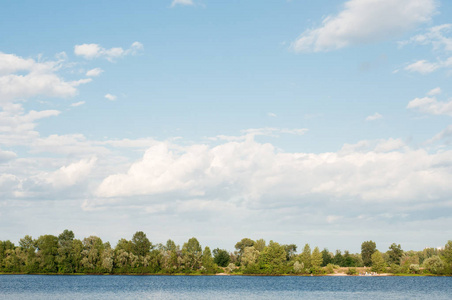 Beautiful landscape. Wide blue river, trees and beautiful sky. 