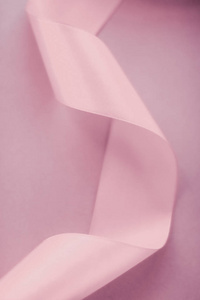 Abstract silk ribbon on blush pink background, exclusive luxury 