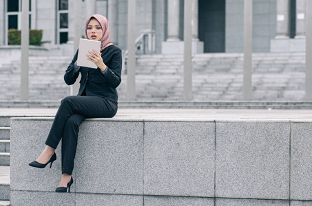 Portrait of cheerful happy businesswoman wearing black suit  sit