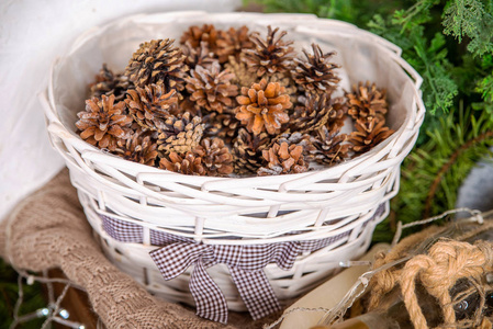 white basket with pine cones 