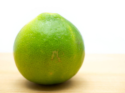 Lime isolated on a wooden floor. 