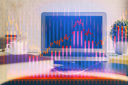 以电脑为背景的彩色财务图表和表格。双重曝光。国际市场的概念。