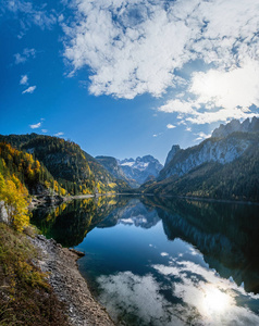 Autumn Alps mountain lake with clouds reflections. Gosauseen or 