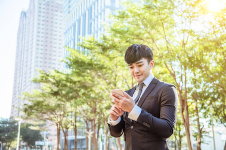 asian young businessman using mobile phone 