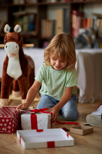 Surprised boy open Christmas presents. 