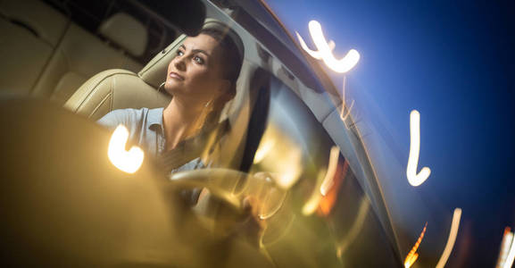 Pretty, young woman  driving a car 