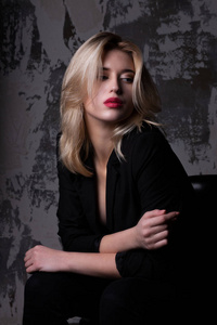 Glamor blonde girl  wearing black jacket 
