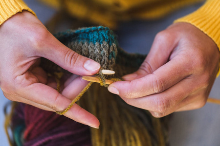 Young woman is knitting. 