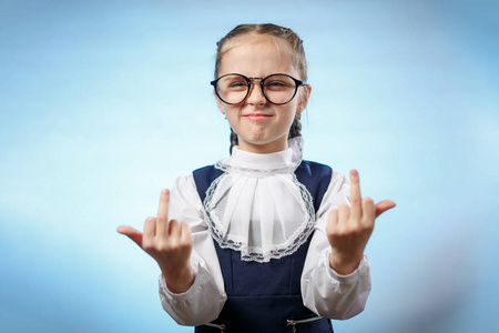 戴眼镜的女学生伸出中指.侮辱性的手势.顽皮的孩子照片