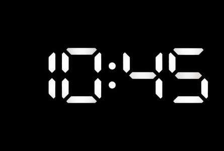 黑色背景上的真正的白色led数字时钟照片