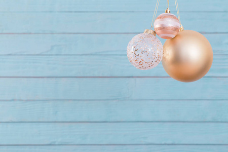 Christmas balls hanging  on  blue wooden background 