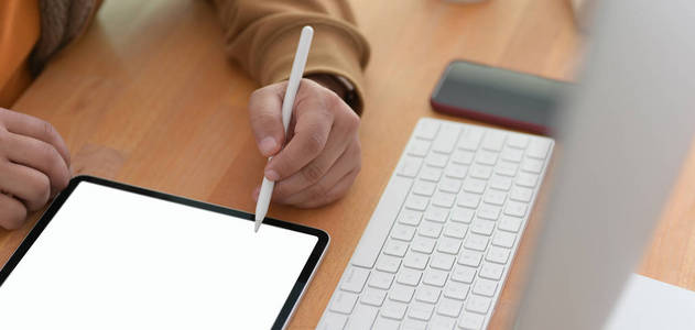 Closeup view of young man working on his project with blank scr