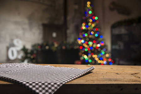 Empty table in front of christmas tree with decorations backgrou