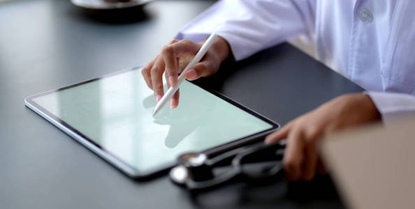 Closeup view of young female doctor working on medical charts w