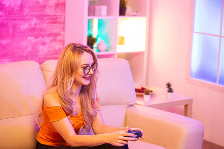 漂亮的金发女孩在玩电子游戏时兴奋不已