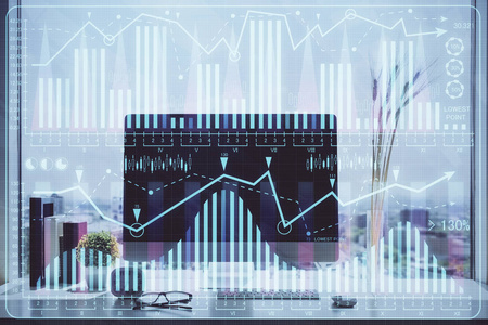 以电脑为背景的彩色财务图表和表格。双重曝光。国际市场的概念。