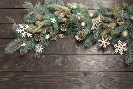 fir branches with Christmas decor on old dark wooden background 