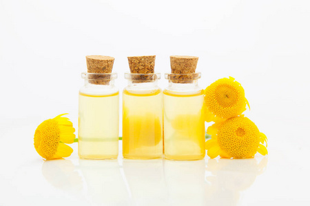 Essence of Yellow Camomille flowers on table in beautiful glass 