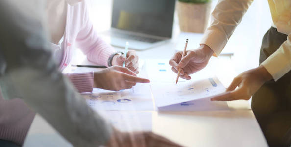 Closeup view of young professional business team brainstorming 