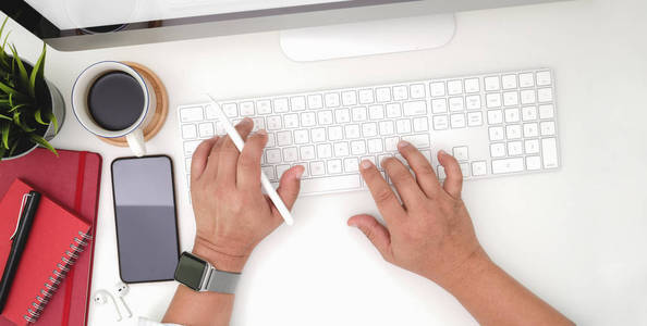 Top view of young businessman typing on keyboard computer in mod