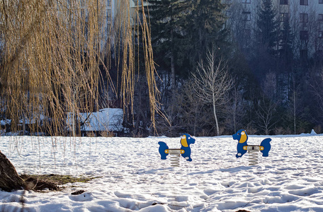 Empty urban playground for kids in winter sunny day