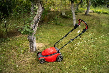 lawn mower on a green grass. Garden view. Special equipment for 