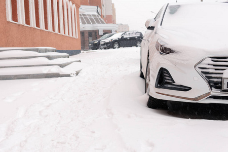 降雪的城市汽车在雪中的街道上