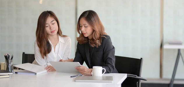 Young professional business people discussing the project togeth