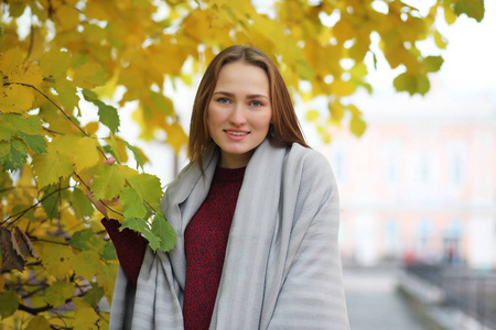 Young girl on a walk in the autumn park 