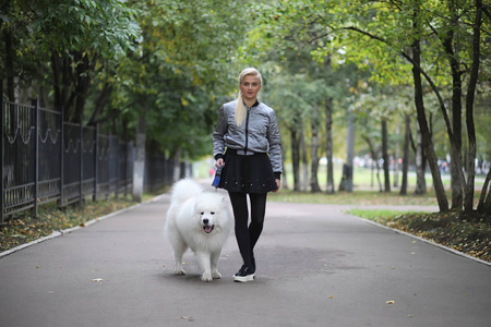 Lovely girl on a walk with a beautiful dog 